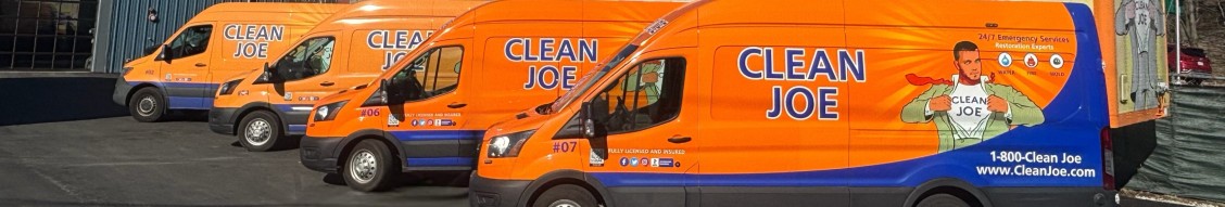 Row of Clean Joe branded service vans parked side by side