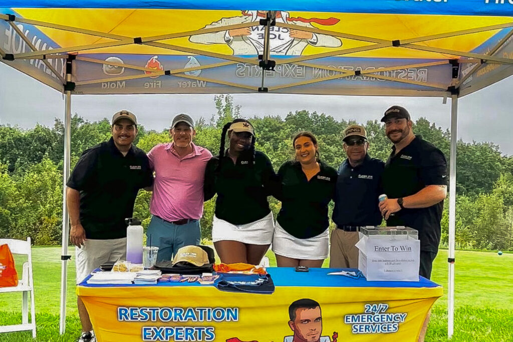 Clean Joe team at a community event under a branded Clean Joe tent